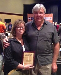 Carole Grills, pictured with Jim Babyak, received the CoSIDA Lifetime Achievement Award in 2013.